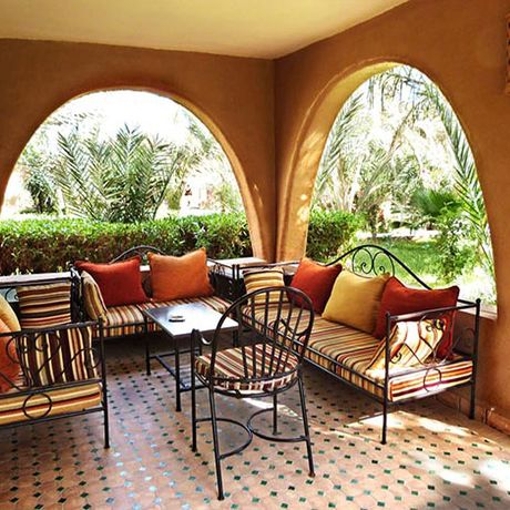 Blick auf einen Sitzbereich auf der Veranda eines Bungalows